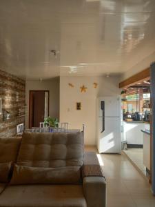 a living room with a couch and a kitchen at Casa da Cris in Florianópolis +19 photos