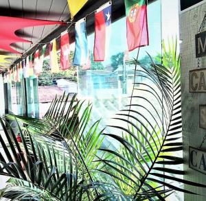 a window of a building with flags hanging from it at Mangue Inn Hostel in Búzios