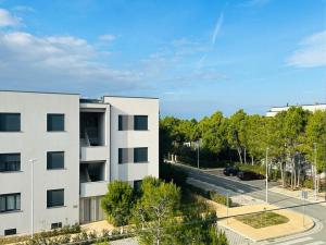 an apartment building with a parking lot and a street at Valamar Cozy Apartment in Hamallë