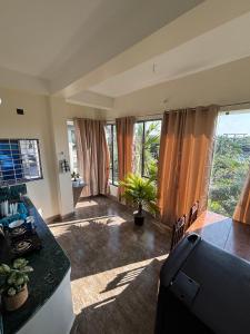 een woonkamer met een aanrecht en een aantal ramen bij Choudhury's Stay in Helāpākari