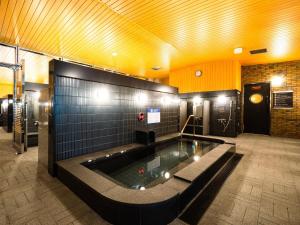 a swimming pool in the middle of a building at APA Hotel & Resort Osaka Namba Ekimae Tower in Osaka