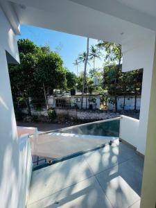 a view from the balcony of a house with a swimming pool at Coastal Bliss Appartments in Varkala