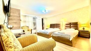 a hotel room with two beds and a couch at Old city Apartment 1 in Tbilisi City