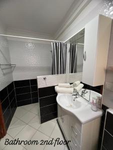 a bathroom with a sink and a shower at APARTMENT AYOUB -for families only- in Nador +50 photos