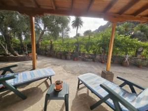 a patio with two picnic tables and two benches at Casa Rosiana in Santa Lucía
