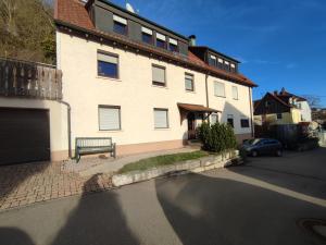 a building with a bench in front of a street at Kaiserberg-Apartments "Auf dem Hohenstaufen" in Göppingen