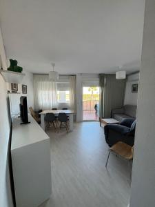 a living room with a couch and a table at Apartamento Sol y Brisa in Matalascañas