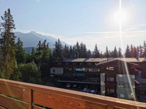 a balcony of a building with a view of a parking lot at Apartman pri boroviciach in Štrbské Pleso