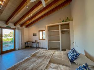a bedroom with a large bed and a table at Blue Door Mallorca in Caʼs Concos