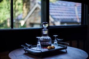 a bottle on a tray on a table next to a window at Aquila Nova Resort in Monbulk