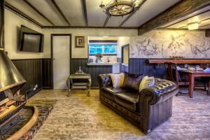 a living room with a couch and a table at Aquila Nova Resort in Monbulk