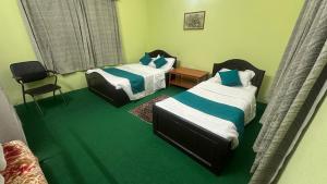 A bed or beds in a room at New Pokhara Lodge - Pokhara Lakeside