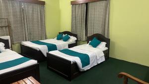 A bed or beds in a room at New Pokhara Lodge - Pokhara Lakeside