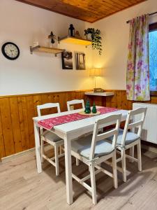 a dining room with a white table and chairs at Chata HANA in Jeseník +14 photos