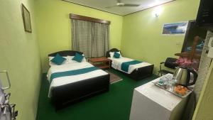 A bed or beds in a room at New Pokhara Lodge - Pokhara Lakeside