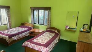 A bed or beds in a room at New Pokhara Lodge - Pokhara Lakeside
