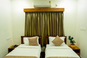 FLY VIEW Airport Residency客房内的一张或多张床位