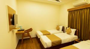 FLY VIEW Airport Residency客房内的一张或多张床位
