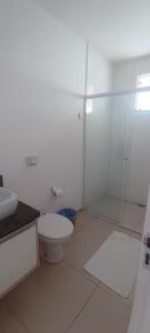 a white bathroom with a toilet and a shower at Pousada BarraVille in Barra Velha +23 photos