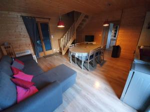 a living room with a couch and a table at Chalet ARREAU in Arreau
