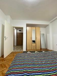 Un dormitorio con una cama grande con una manta a rayas. en casa Felice, en Bitola