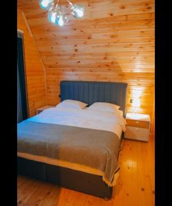 a bedroom with a bed in a wooden cabin at 7Sense Nature Resort in Sapanca +21 photos