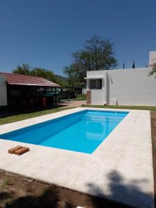 a swimming pool in front of a house at Aires de San Antonio in San Antonio de Arredondo