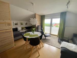a living room with a bed and a table in a room at Gästehaus Natur in Vöhl