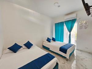 Postel nebo postele na pokoji v ubytování Hotel YUMA TATACOA