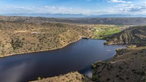 an aerial view of a reservoir in a valley at Aardvark Bioreserve in Ladismith
