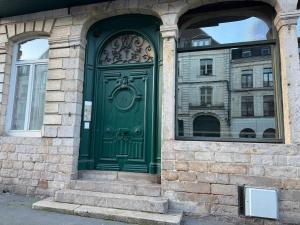 a green door on the side of a building at Haring spot in Arras +8 photos