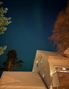 a building with lights on the side of it at night at Apartment in Tromsø in Tromsø