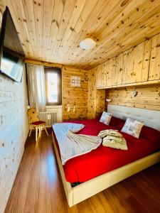 sypialnia z dużym łóżkiem w drewnianym pokoju w obiekcie Home, sweet home w Livigno