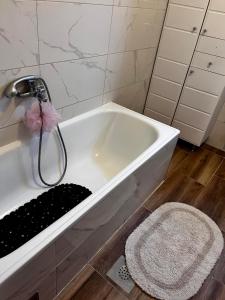 a bathroom with a bath tub with a pink toy at Comfort&Peace in Sarajevo