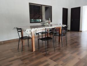 a marble table and chairs in a room at Creek Side in Madikeri