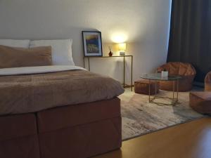 a bedroom with a bed and a table and a chair at Designer Wohnung Erfurt Auenstr in Erfurt +8 photos