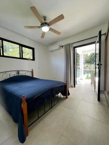 a bedroom with a bed and a ceiling fan at Villa Valentina Cabarete Procab in Cabarete +7 photos