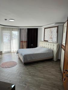 a bedroom with a large bed in a room at Ella Willa Suite House Butik Otel in Gure +1 photo