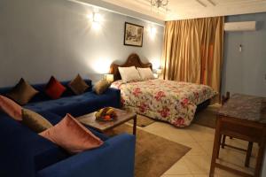 a hotel room with a bed and a blue couch at Appart-Hôtel BEL ANFA in Casablanca +57 photos