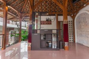 a large kitchen in a building with wooden ceilings at Iconic Lodge Uluwatu in Uluwatu