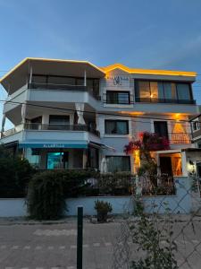 a large apartment building with a sign on it at Ella Willa Suite House Butik Otel in Gure