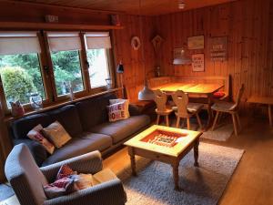 a living room with a couch and a table at Ferienhaus Henri in Bruderhalde