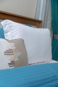 a close up of a bed with a pillow on it at Urban Elite Stay in North Legon