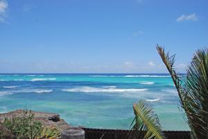 a view of the ocean from a beach at Inch by Inch home by Bluescape in Christ Church