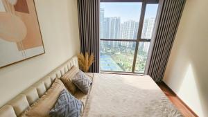 a bed in a room with a large window at Ocean apartment in Gia Lâm Pho +32 photos