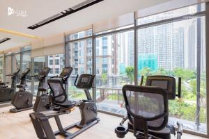 a gym with cardio machines and a large window at Ocean apartment in Gia Lâm Pho