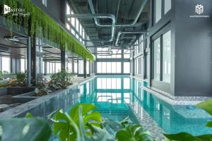 a swimming pool in a building with plants at Ocean apartment in Gia Lâm Pho