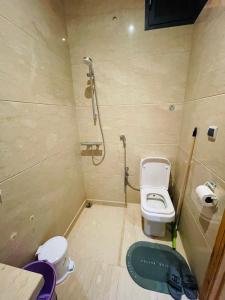 a small bathroom with a toilet and a shower at Entire Villa Garden Wi-Fi Near Beach in Agadir +41 photos
