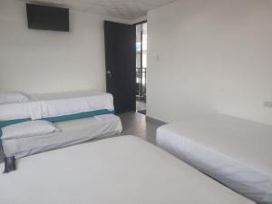 Postel nebo postele na pokoji v ubytování Hotel YUMA TATACOA