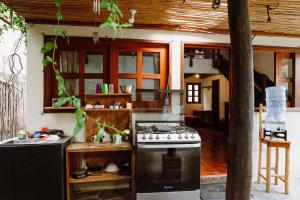 a kitchen with a stove top oven in a house at Casa Mike, San Marcos La Laguna in San Marcos La Laguna